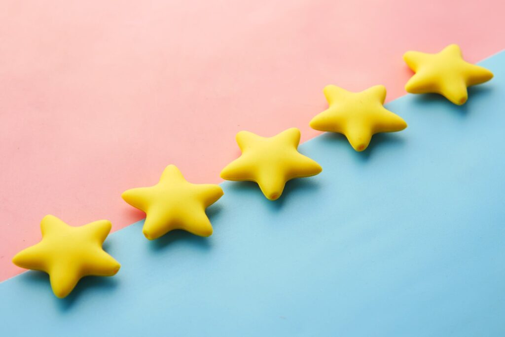 5 Yellow Plastic Stars On Pink & Blue Background